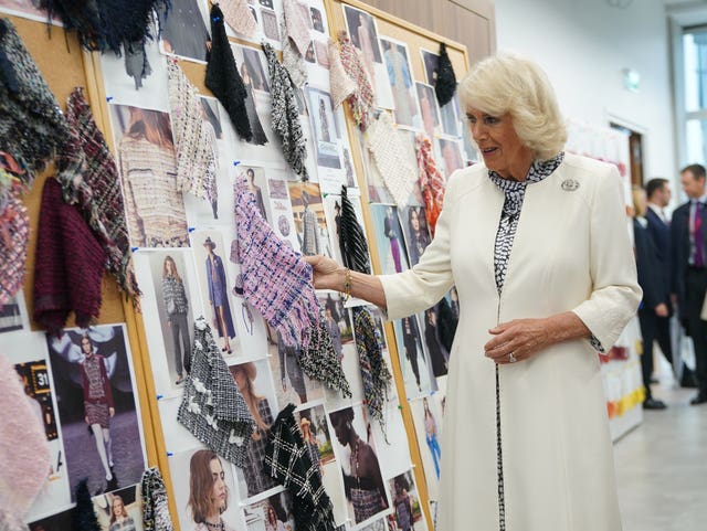 Camilla looks at samples of woven fabrics