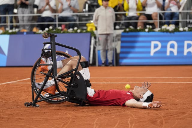 Japan’s Tokito Oda falls to the court after winning gold (Andrew Matthews/PA)