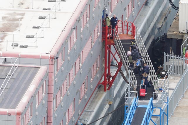 People boarding the Bibby Stockholm accommodation barge at Portland Port in Dorset (James Manning/PA)