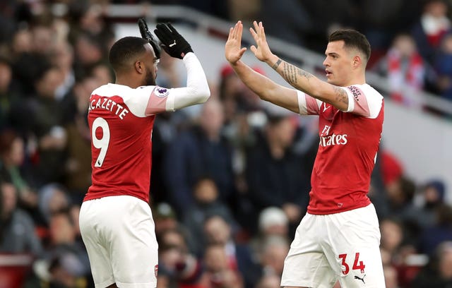Granit Xhaka, right, celebrates after helping Arsenal to beat Manchester United 