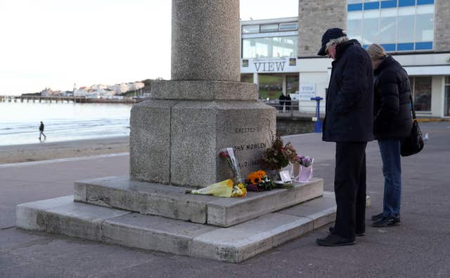 Tributes left at the King Alfred Monument on the seafront in Swanage 