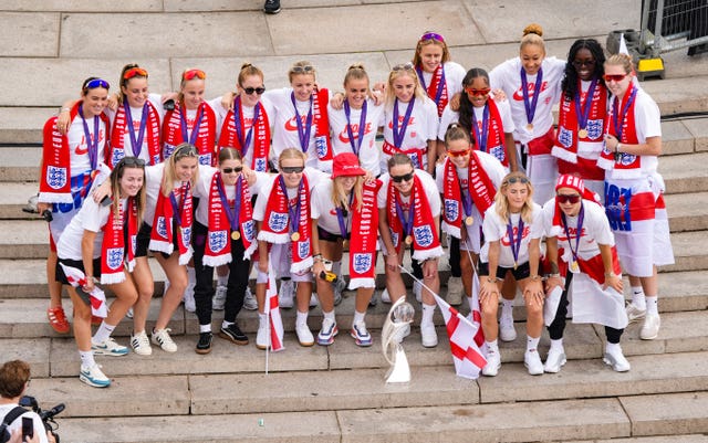 England players gather on the steps of the Victoria Memorial during a Homecoming Victory Parade