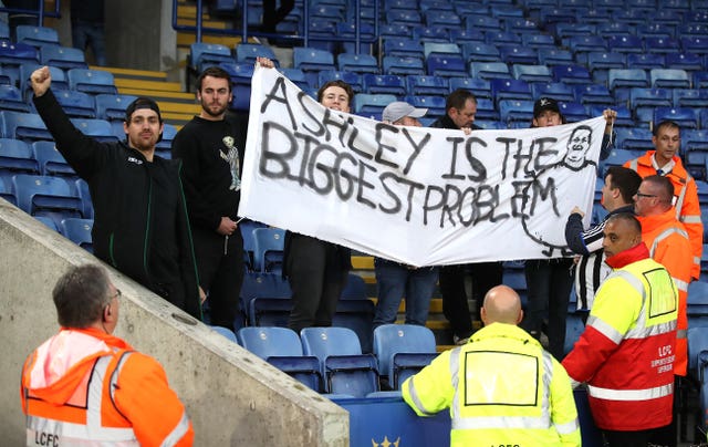 Fans hold a sign saying ‘Ashley is the biggest problem’