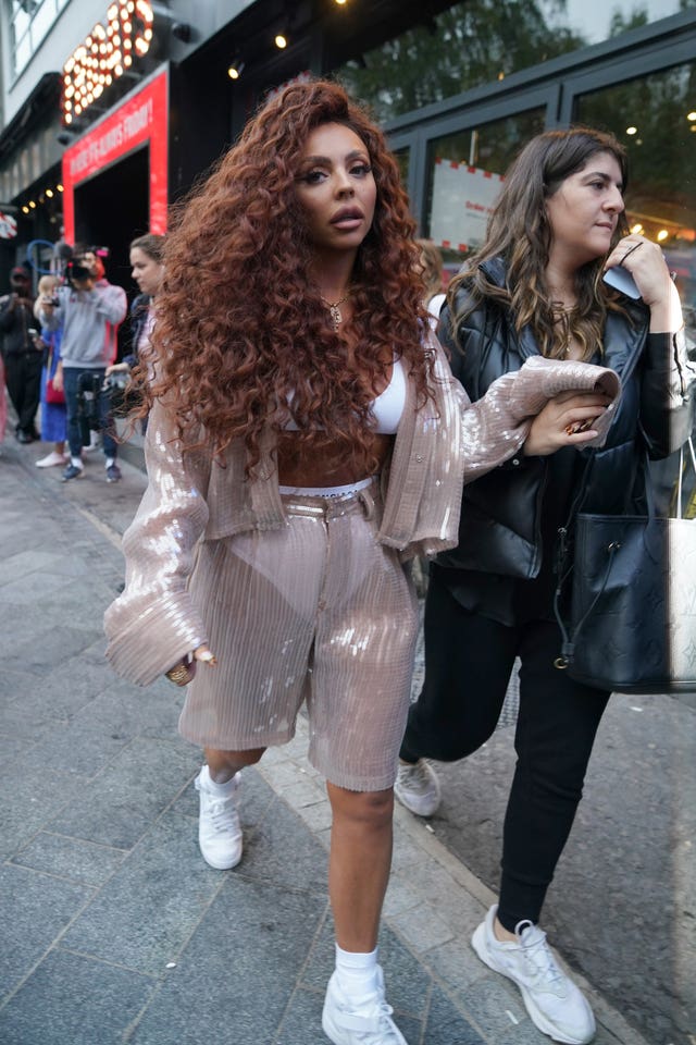 Jesy Nelson walking along a street 