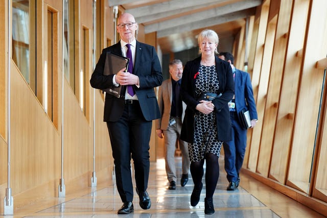 John Swinney and Shona Robison walking along a corridor at Holyrood