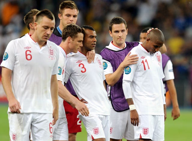 England players try to console Ashley Cole and Ashley Young after they fail to convert in the shoot-out