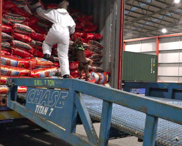 An officer unloads bags of rice which contained heroin at the port of Felixstowe