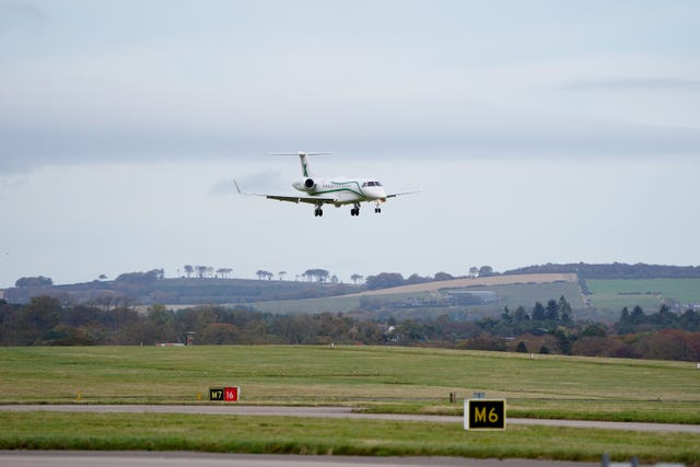 The plane carrying the body of former first minister of Scotland Alex Salmond lands at Aberdeen Airport