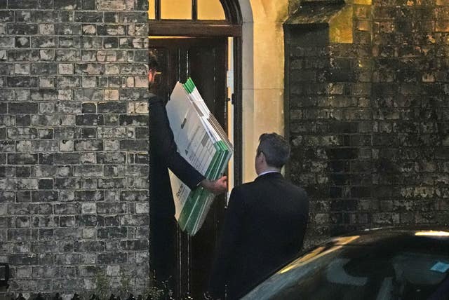 Empty flat pack boxes are taken into the home of Lord Peter Mandelson in north-west London