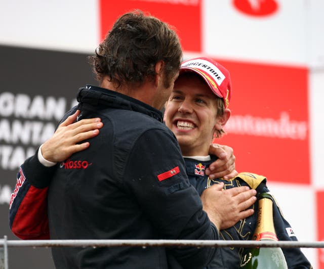 Former Toro Rosso team boss Gerhard Berger celebrates with Vettel following the German's maiden win of his career at the 2008 Italian Grand Prix (David Davies/PA)