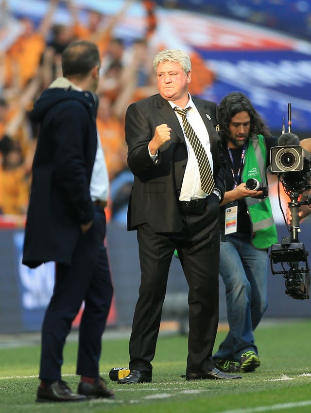 Steve Bruce celebrates dragging Hull back into the Premier League after play-off final victory over Sheffield Wednesday at Wembley