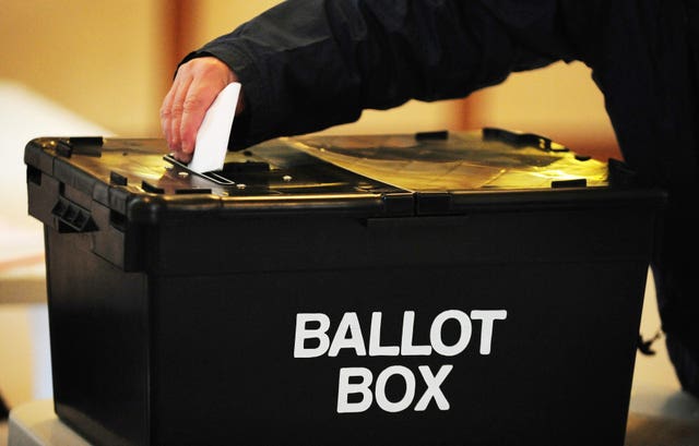 A voter placing a ballot paper in the ballot box