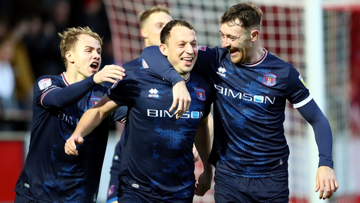 Kristian Dennis, centre, scored twice for Carlisle (Tim Markland/PA)