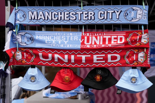 Manchester United and Manchester City scarves on a trade stall.