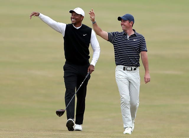 Tiger Woods and Rory McIlroy wave to the stands at the 150th Open Championship