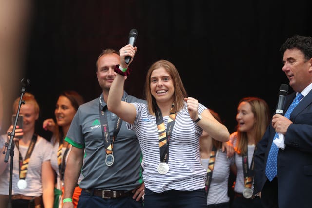 Coach Graham Shaw and captain Katie Mullan wave to crowds