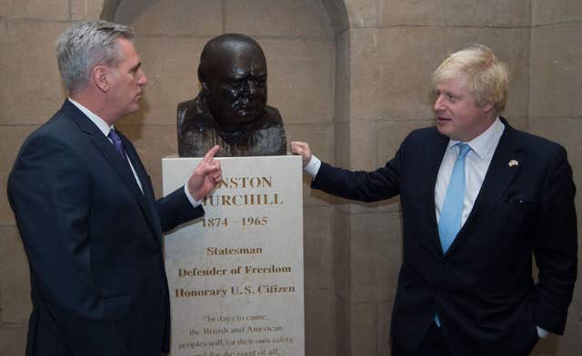 Boris Johnson, right, alongside a bust of Churchill