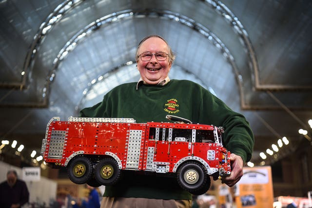 George Illingworth holds a model fire engine 