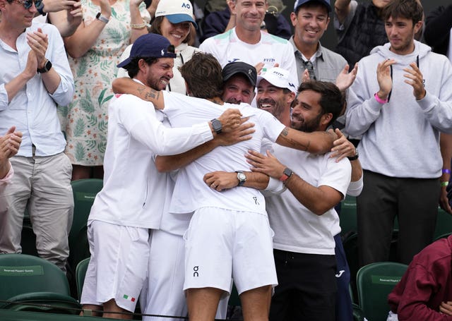 Flavio Cobolli hugs his team after reaching the quarter-finals