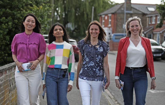 Lucia Hunt, wife of Chancellor Jeremy Hunt, Akshata Murty wife of Prime Minister Rishi Sunak, Culture Secretary  Lucy Frazer and Susie Cleverly wife of Home Secretary James Cleverly walking together along a street