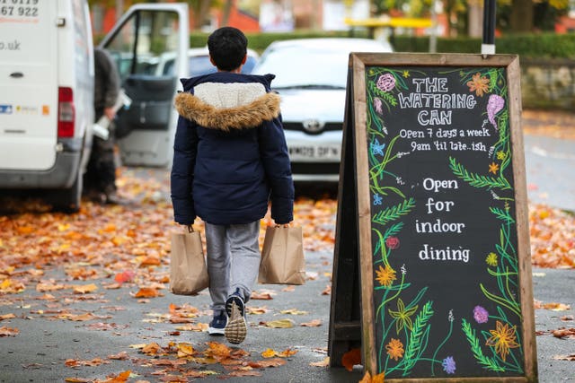 Child collects packed lunch bags