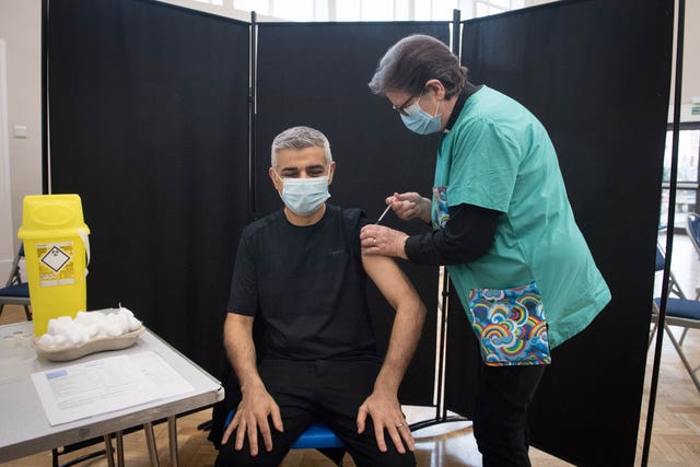 Mayor of London Sadiq Khan receives his first dose of the Pfizer vaccine from Dr Sue Clarke at a Covid-19 vaccination clinic at the Mitcham Lane Baptist Church, south London 