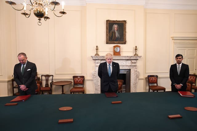 Prime Minister Boris Johnson stood alongside Cabinet Secretary Mark Sedwill and Chancellor Rishi Sunak to observe the silence at 10 Downing Street