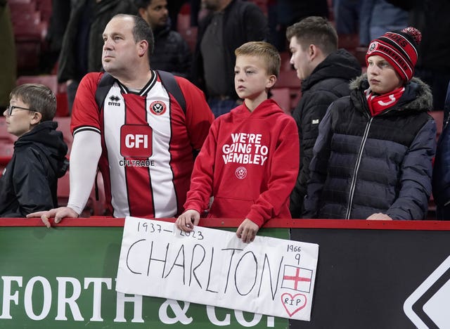 Sheffield United fans in the stands with a tribute in memory of Sir Bobby Charlton