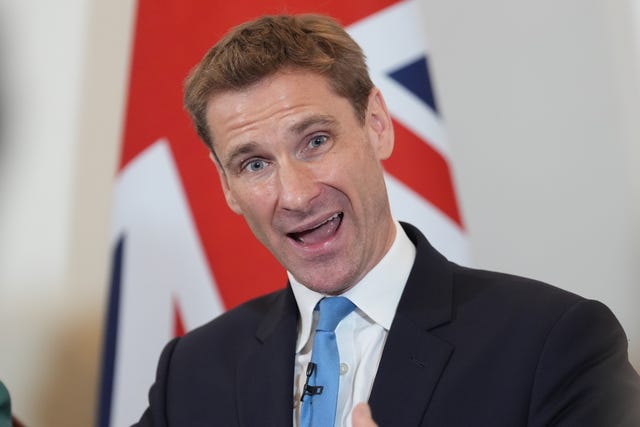 Chris Philp standing in front of a Union flag