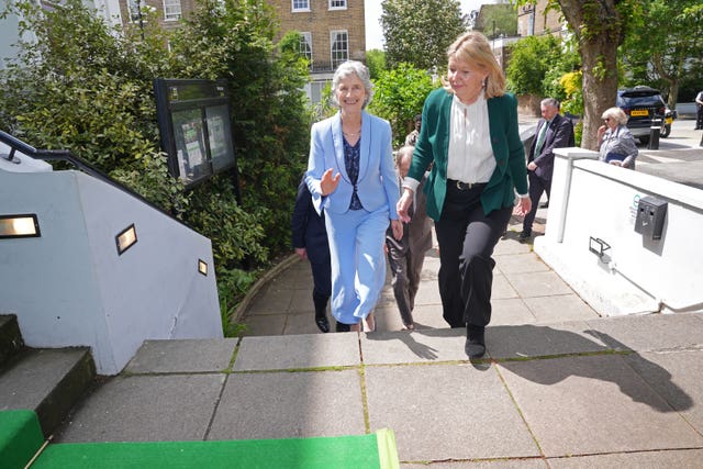 Irish President Catherine Connolly, left, arrives at the London Irish Centre in Camden, north London