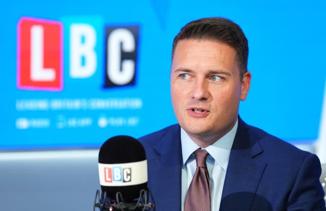 Health Secretary Wes Streeting speaking into a microphone in an LBC studio 