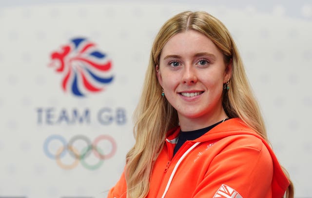 Emma Finucane poses for a photo with the Team GB logo behind her. 