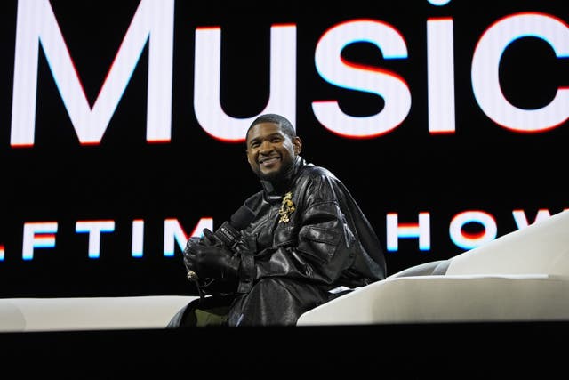 Usher speaks on stage during the Apple Music Super Bowl half-time show press conference