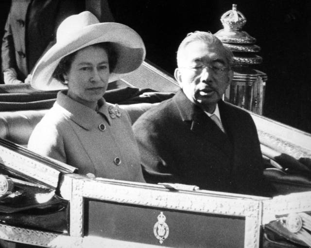 The Queen and Emperor Hirohito of Japan drive in an open carriage to Buckingham Palace, at the start of his State visit to Britain (Archive/PA)