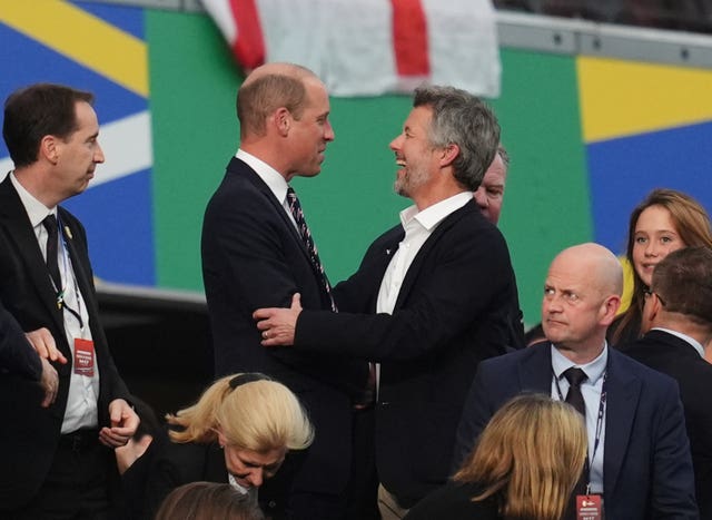 The Prince of Wales and King Frederik X of Denmark in the stands after the match in Frankfurt