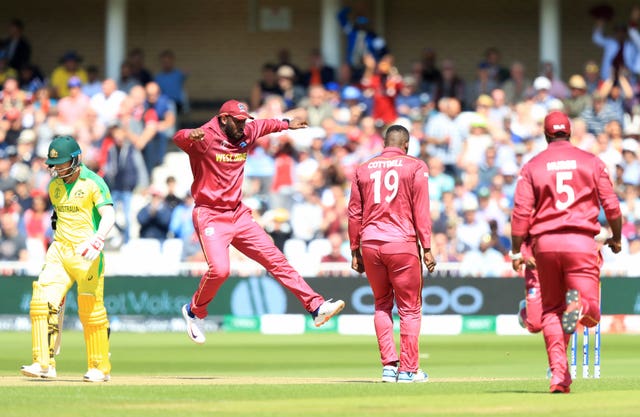 West Indies celebrate the wicket of David Warner