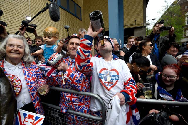 Royal fans celebrate outside the Lindo Wing after the news was announced (Kirsty O'Connor/PA)