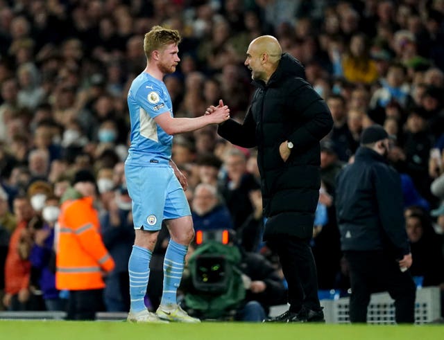 Manchester City’s Kevin De Bruyne speaks with manager Pep Guardiola after being substituted during the Premier League match at the Etihad Stadium, Manchester. Picture date: Wednesday April 20, 2022