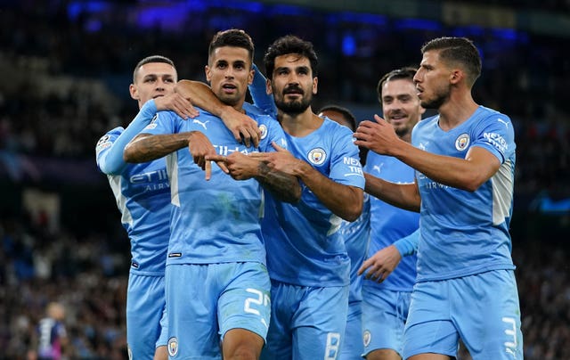Joao Cancelo celebrates with fellow Manchester City players
