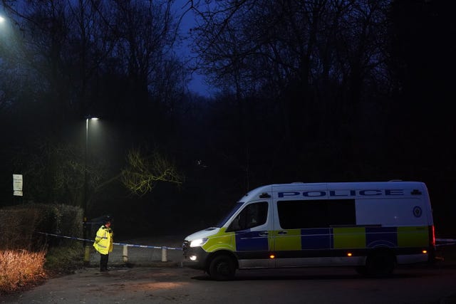 Police officers work in the dark