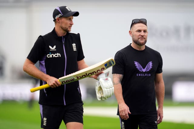 England head coach Brendon McCullum, right, with Joe Root during a net session