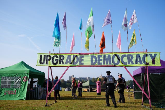 Police monitor the protest camp