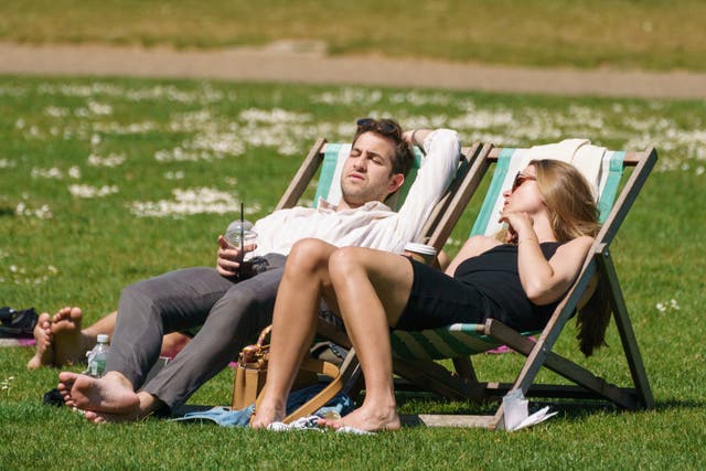 People sitting in deck chairs in hot weather