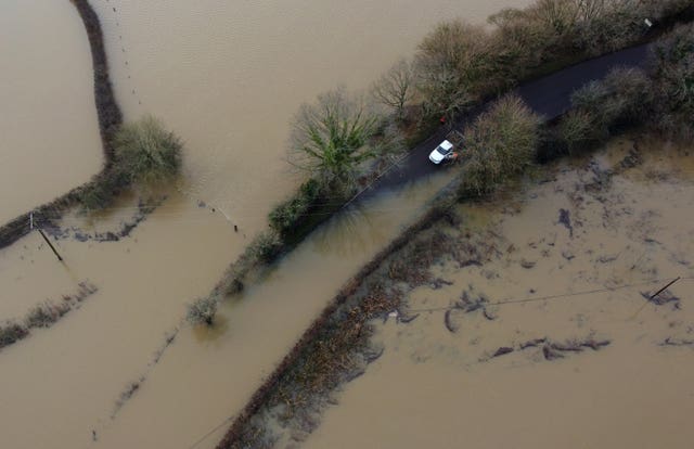 A van avoids flood water from the River Ouse in Barcombe Mills, East Sussex