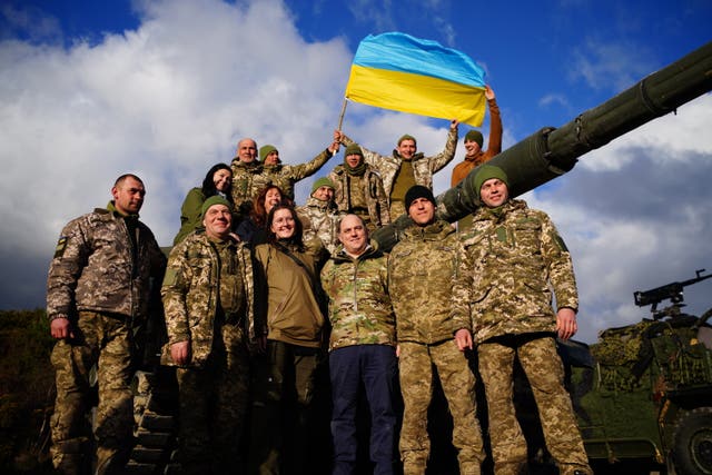 Secretary of Defense Ben Wallace (centre right) with Ukrainian soldiers during a visit to Bovington Camp to watch their training on Challenger 2 tanks in February