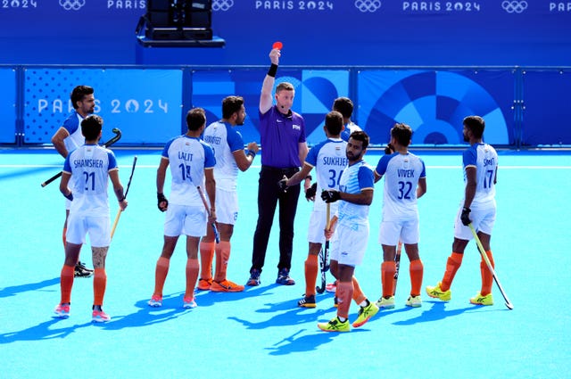 India’s Amit Rohidas is sent off by umpire Sean Rapaport, who raises a red card.