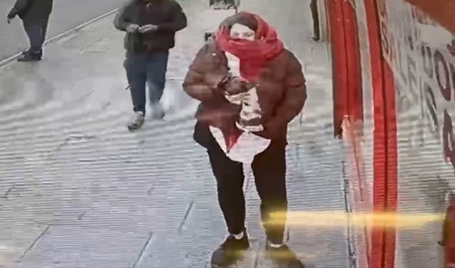 Still from CCTV footage of Constance Marten holding baby Victoria under her coat
