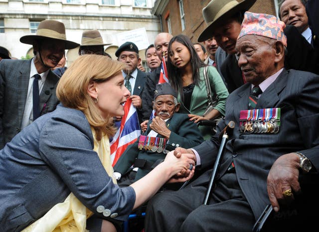 Sarah Brown shaking hands with a Gurkha in the garden of Downing Street 