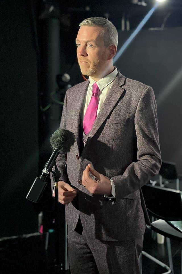 Green party leader Mal O’Hara standing on a darkened stage talking