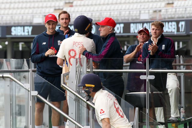 England’s Ollie Pope is congratulated by captain Joe Root 